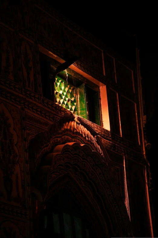a green light illuminates a po on the corner of a window