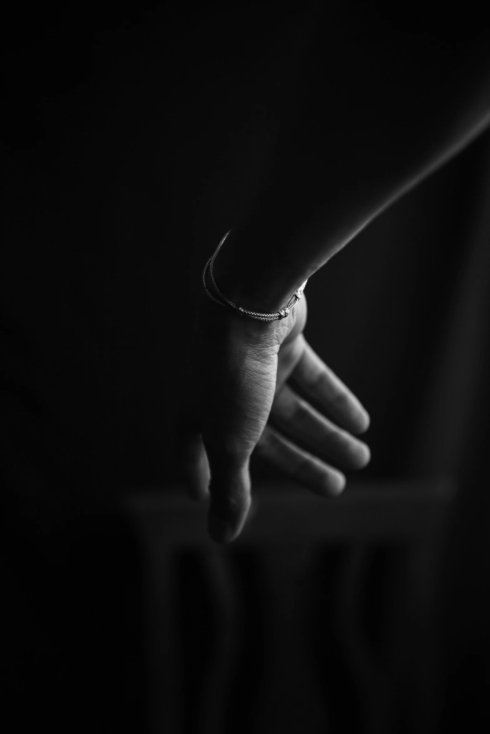 a woman's hand with a diamond celet