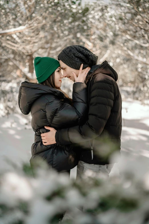 a couple posing together in the snow for an attractive po