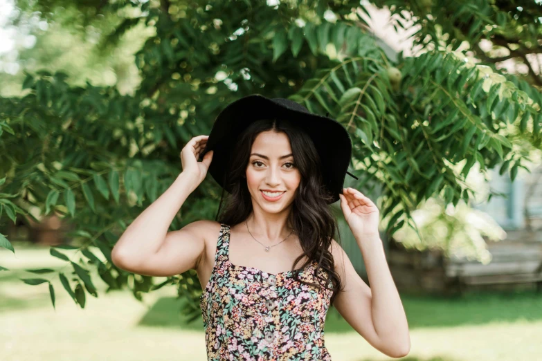 a girl in a floral top and a hat