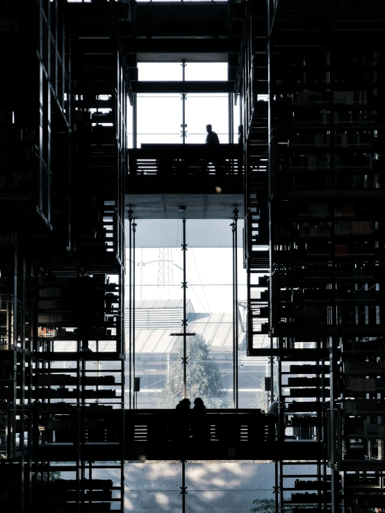 silhouettes of people on a bench in an liry