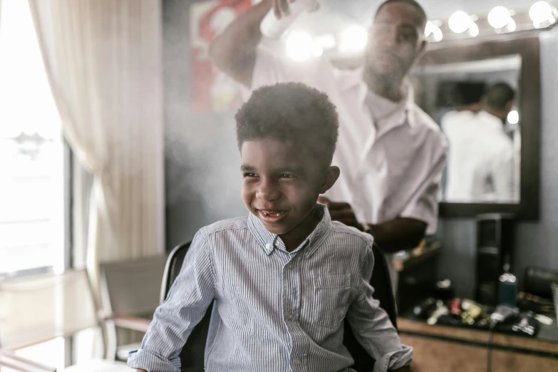 a  getting his hair cut at the barber