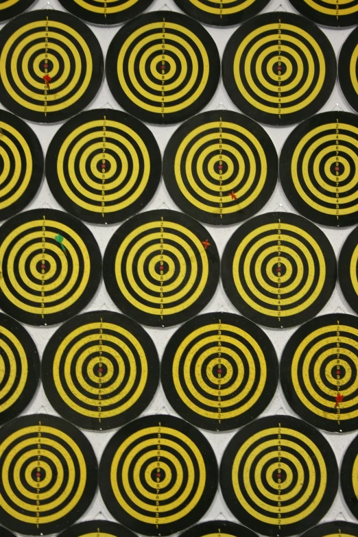 several yellow and black circles on the side of a target