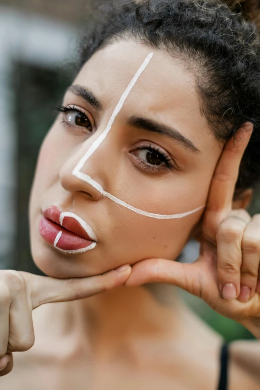 a woman has white tape taped to her face