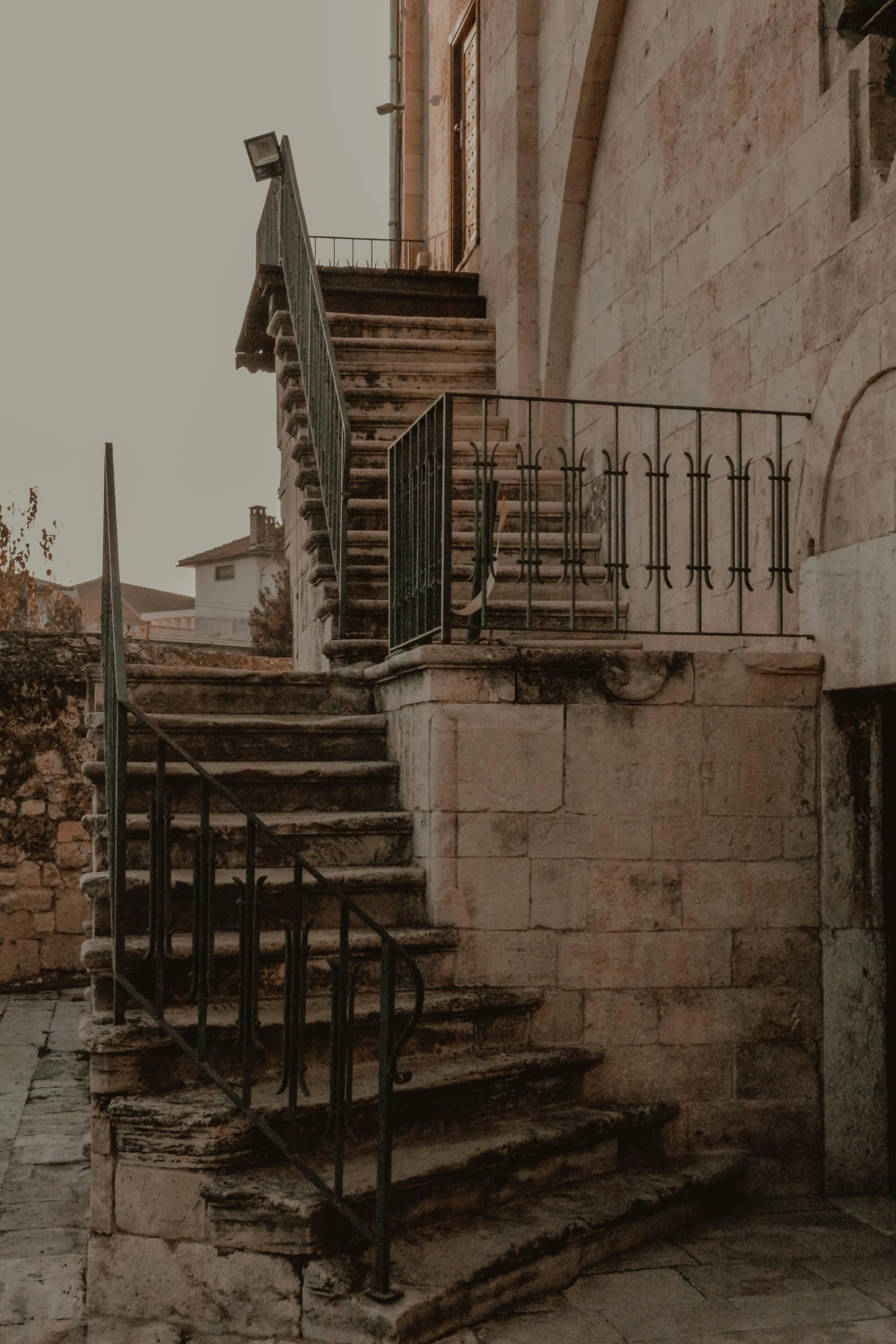 the stairs are brown and brick along with the door way