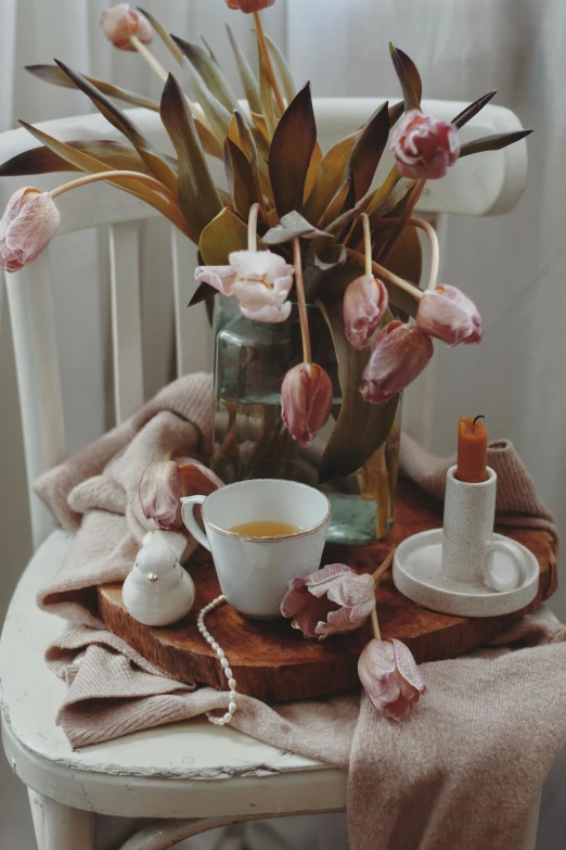 a pretty bouquet of flowers sit in front of a cup of coffee