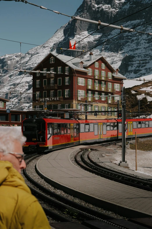 a person standing near an old passenger train