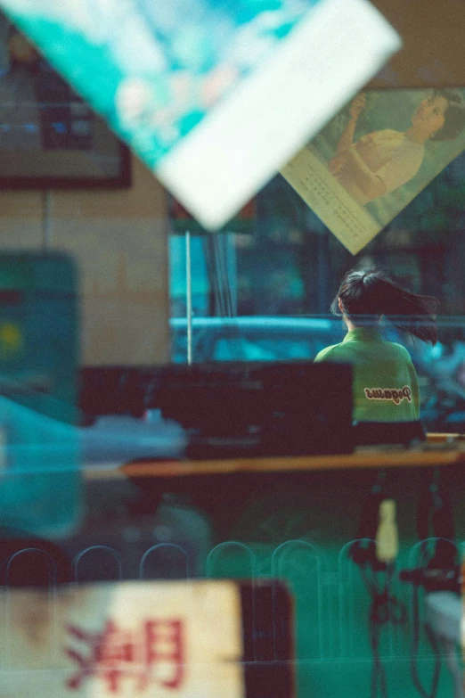 a blurry po of a restaurant counter and a person sitting at a table