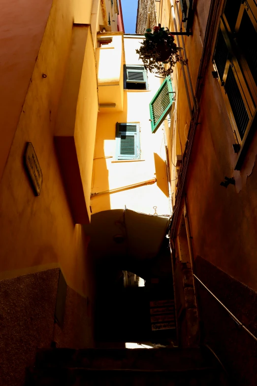 an alleyway with stairs between buildings