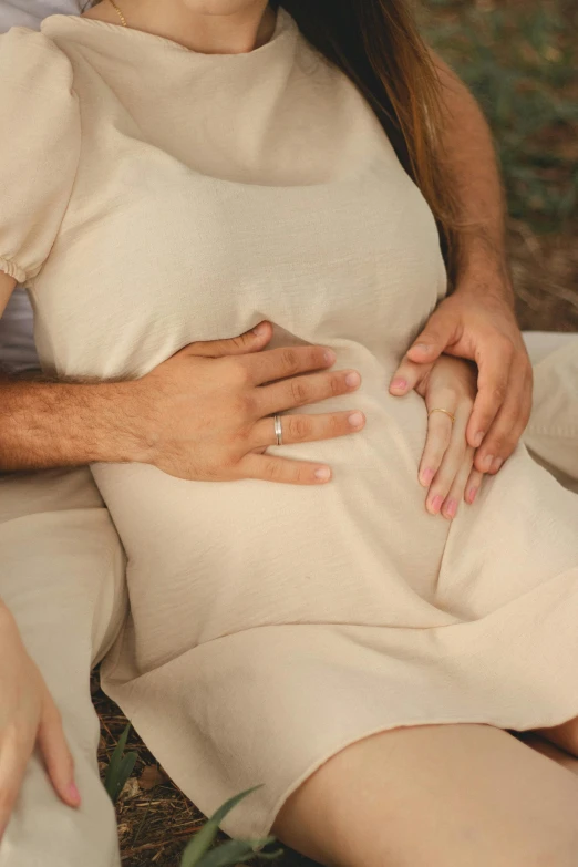 a couple cuddling in the park and holding hands