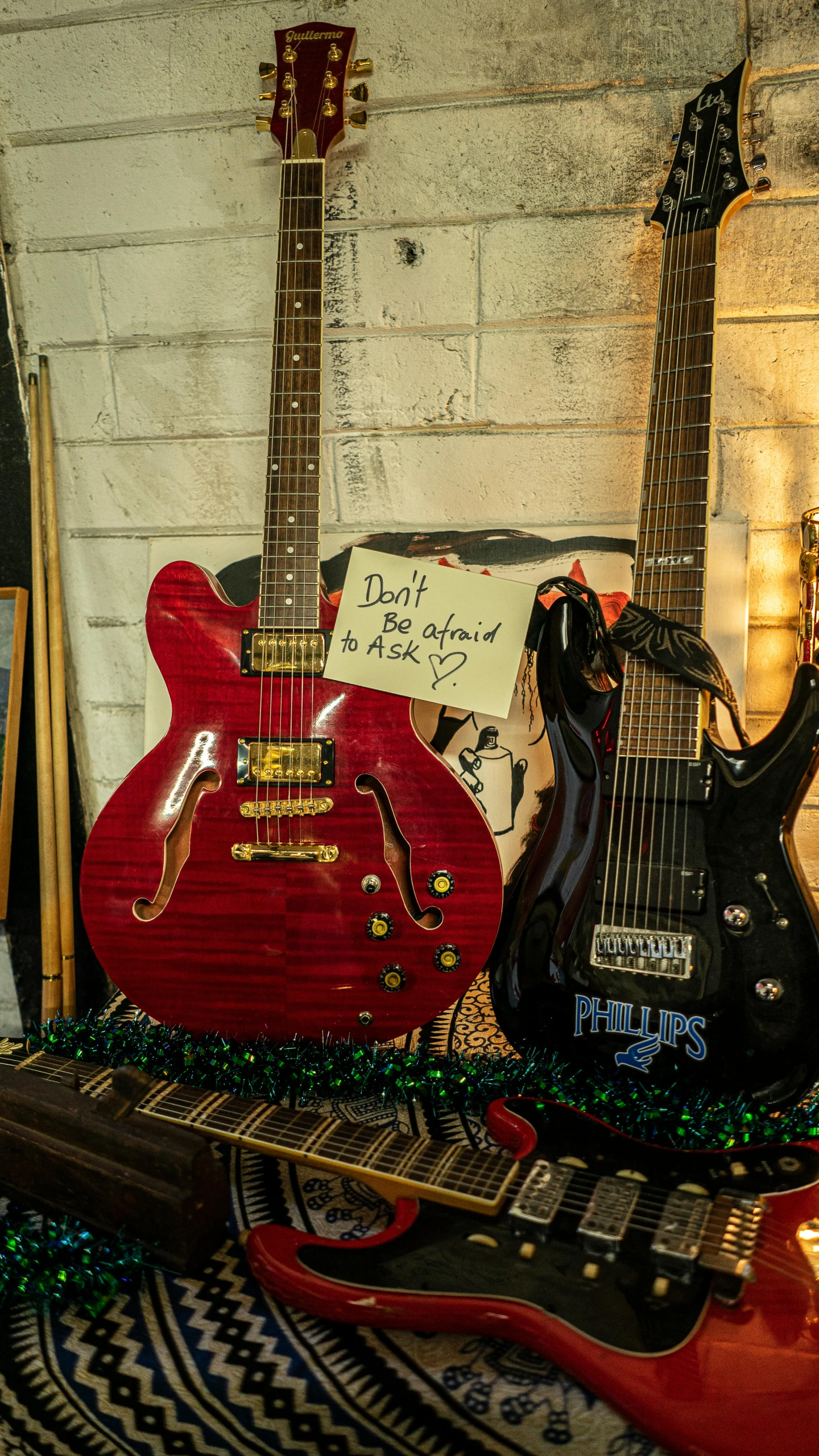 a red and black guitar with an ugly christmas decoration