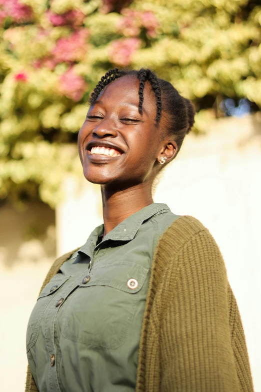 a woman is smiling and wearing her hair up