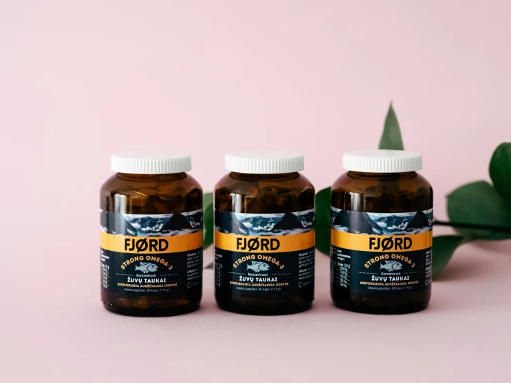 three bottles of fiord vitamin drink on top of a table