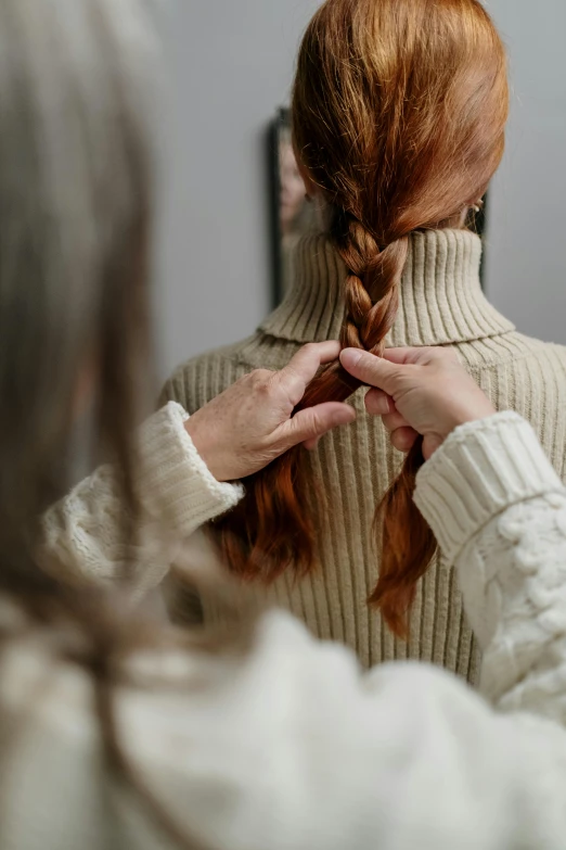 a person ids her hair in the bathroom