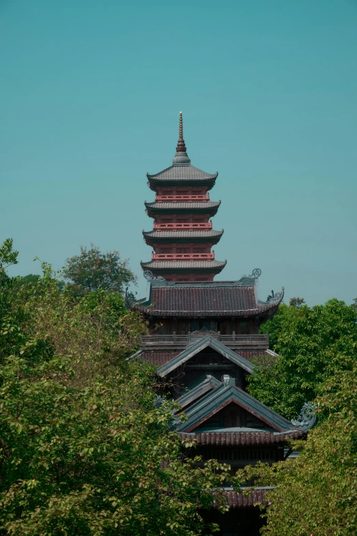 tall brick tower surrounded by trees and shrubbery