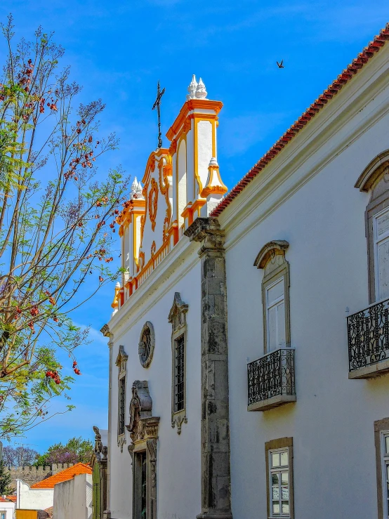 a tall white building with a clock tower