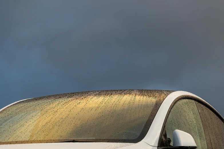 the front window of an old car with rain drops