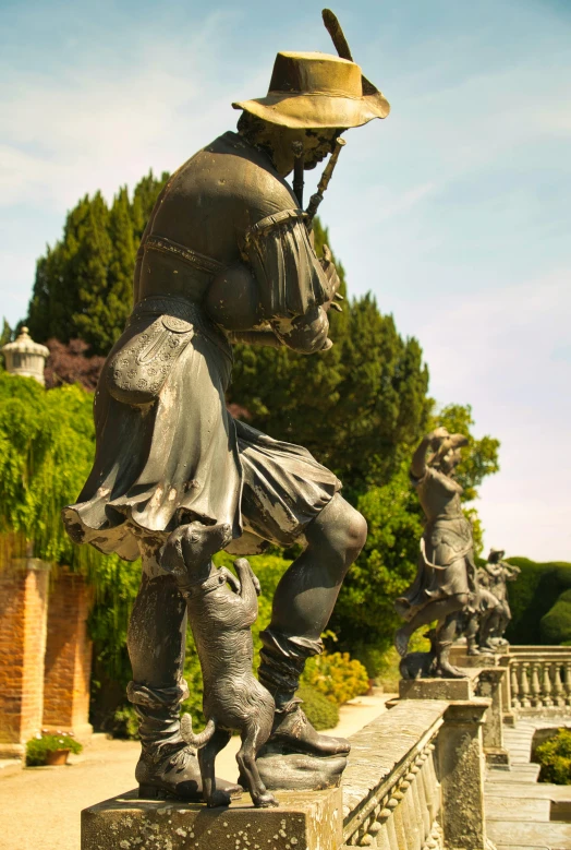 a statue of a man wearing a hat and holding a pipe in his mouth