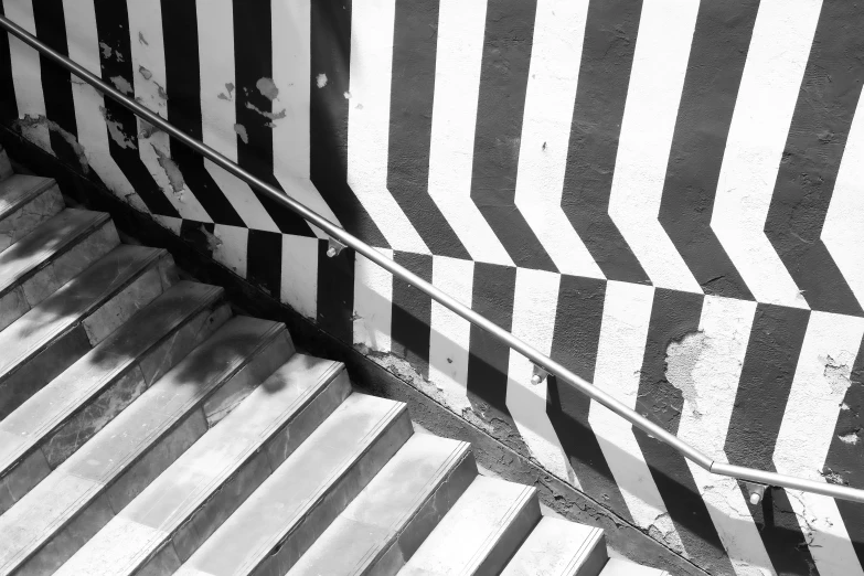 black and white pograph of striped wall with arrow