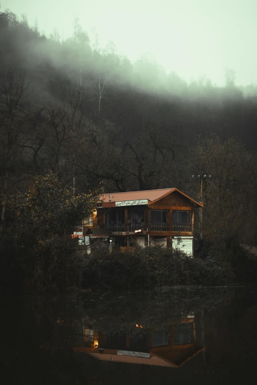 a building sitting on top of a lush green hillside