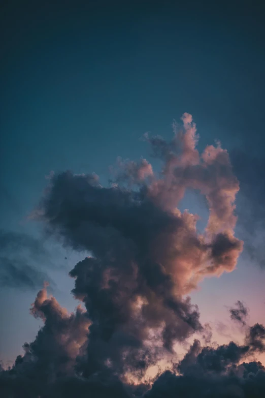 a view of a airplane flying with a colorful sky