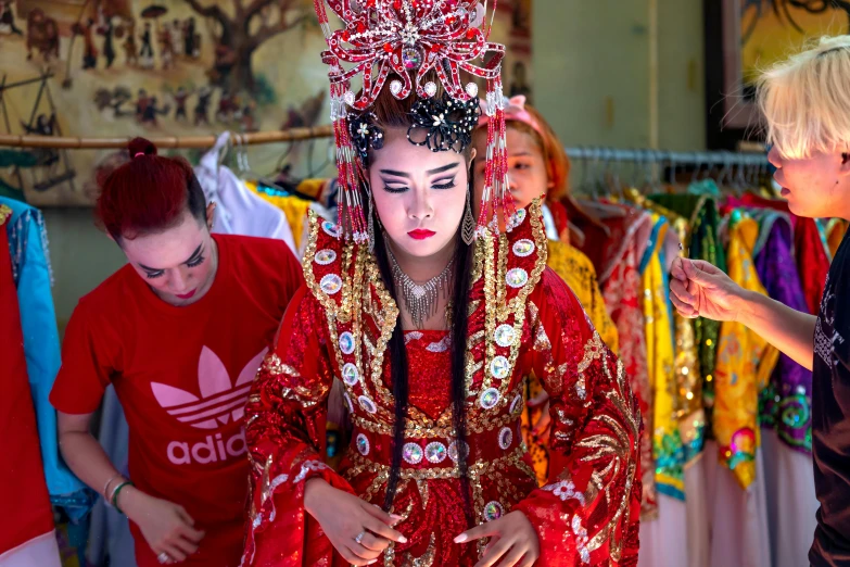 a woman in traditional chinese costume walking by clothes