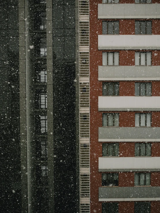 buildings with windows are seen covered in snow