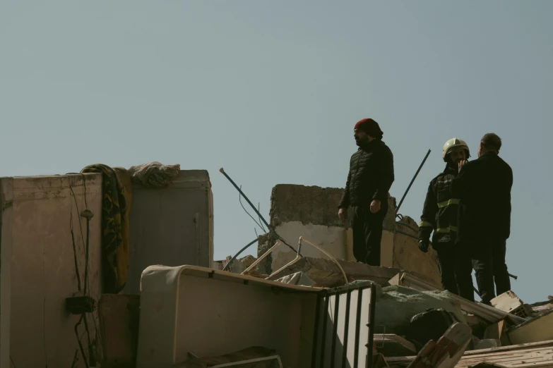 men standing on a demolished building looking up into the sky