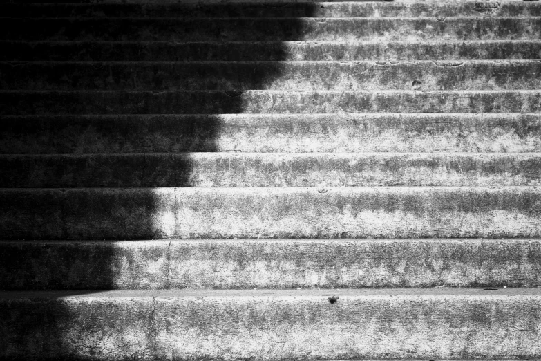 a man in a white coat and a hat walking up stairs