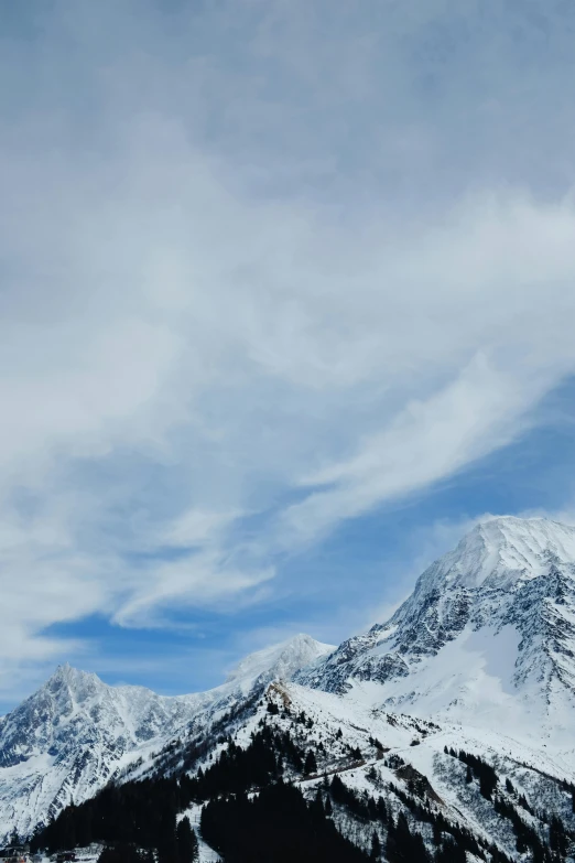 two snowboards are leaning against the tops of a snowy mountain