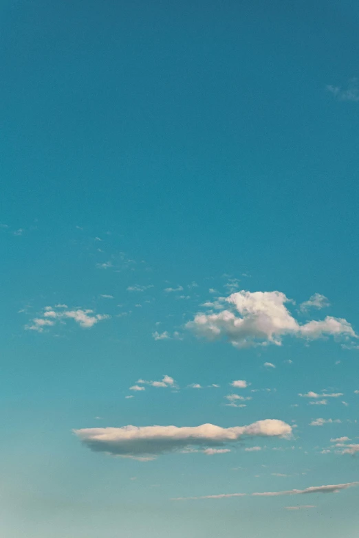 several people are on the beach and one is flying a kite