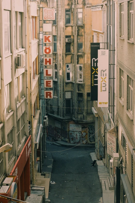 a narrow city street with a bunch of signs