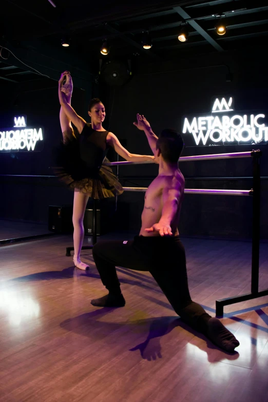 two dancers are practicing on a hard wood floor