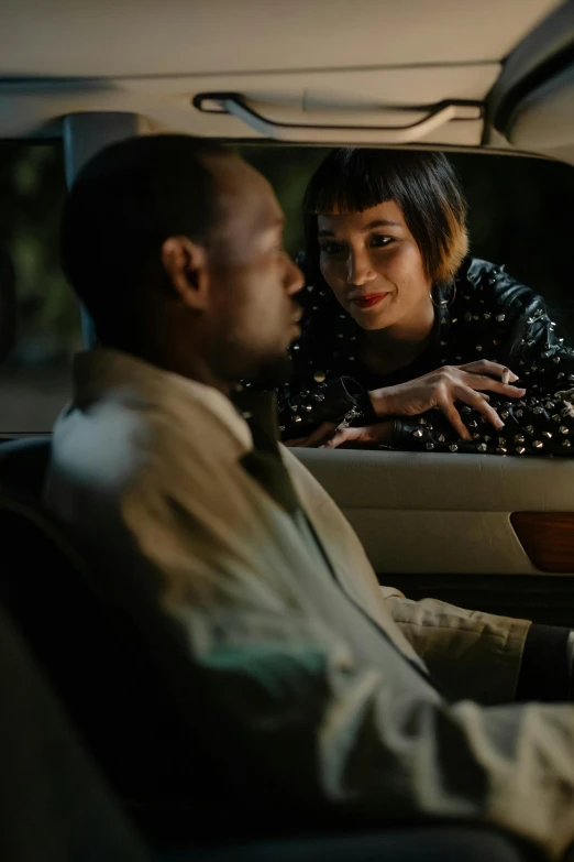 a man and woman sitting in a vehicle