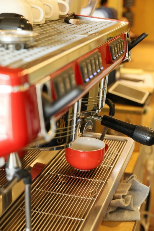 the machine is making coffee for people at a restaurant