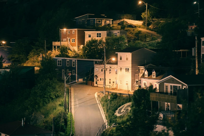 small house on top of a hill with a driveway