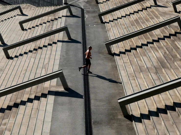 a person walking down an inclined path near buildings