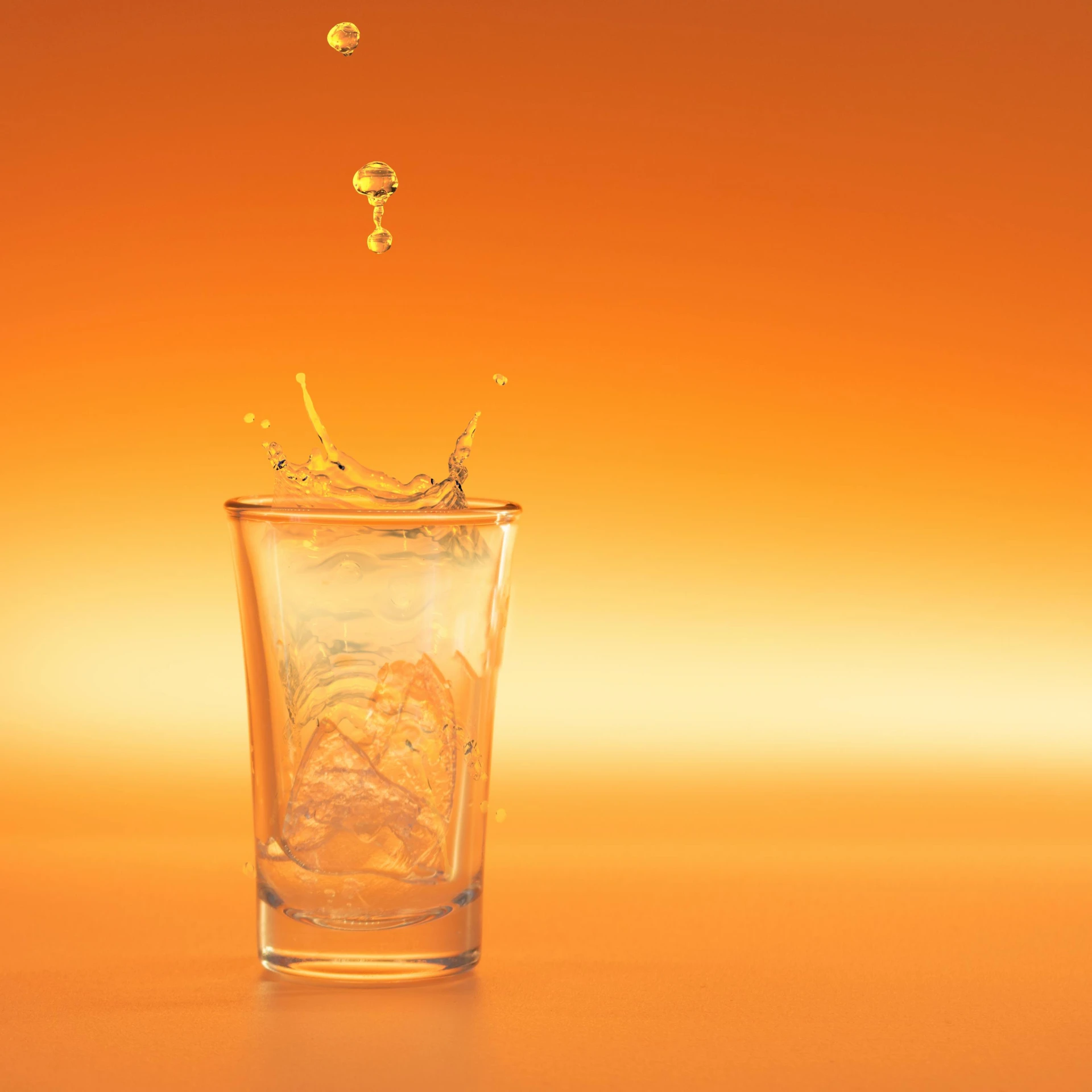 a glass of water has some gold splashing around