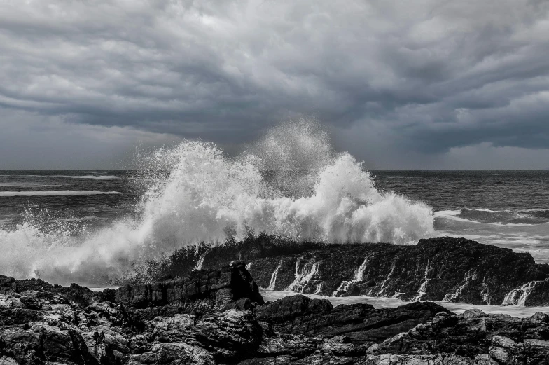 a storm rolling over the ocean and a crashing wave