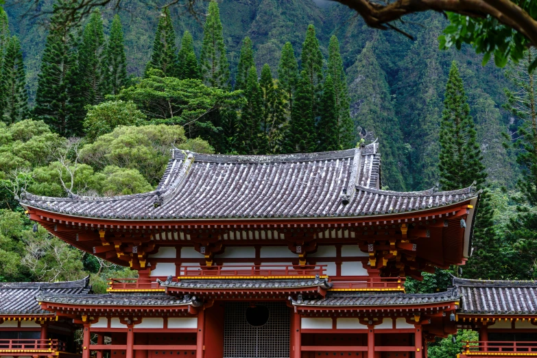 a red building with two yellow doors and some trees