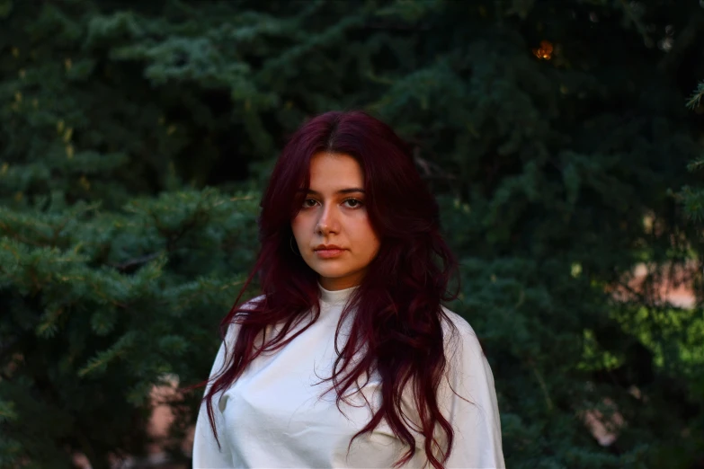 a beautiful young woman with long hair holding a white frisbee