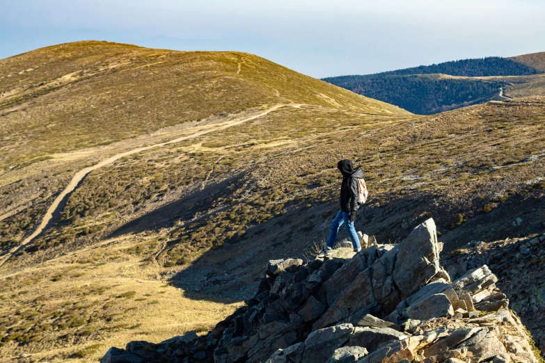 a person standing on top of a rock formation