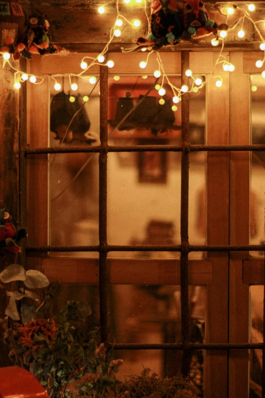 the inside of a house lit up by fairy lights