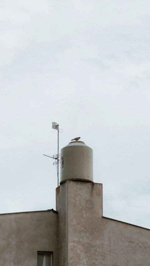 an old building with a weather vein on top