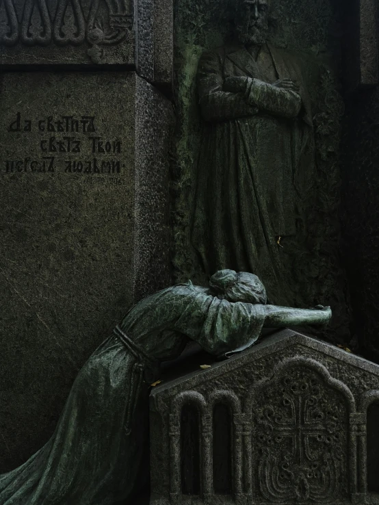 a statue and tombstones with a woman standing over it