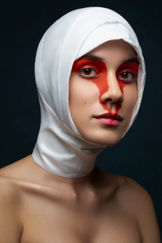 a woman with red paint painted on her face
