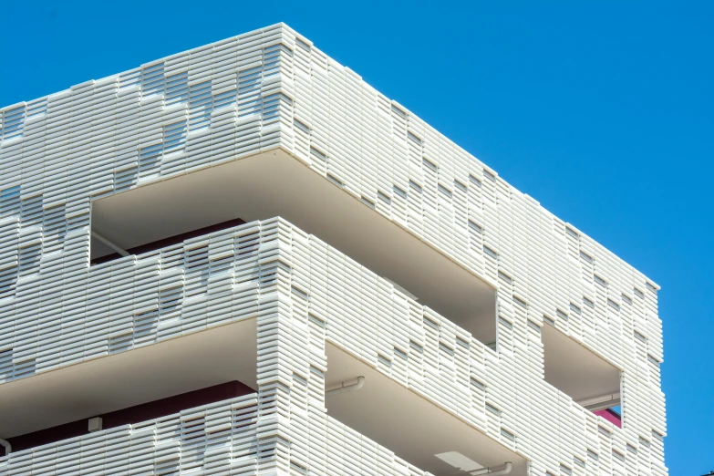 two story building made of bricks with a blue sky in the background