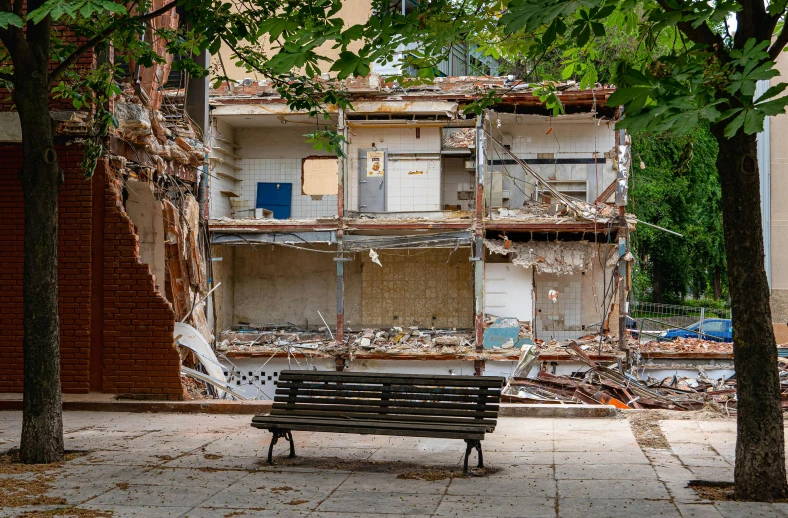 a park bench sitting in front of an old building