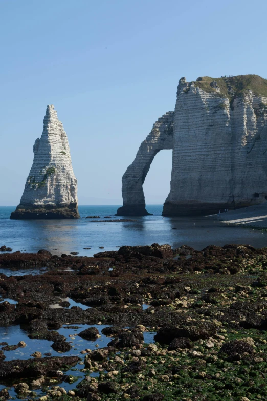 the rocks are on shore with water below them