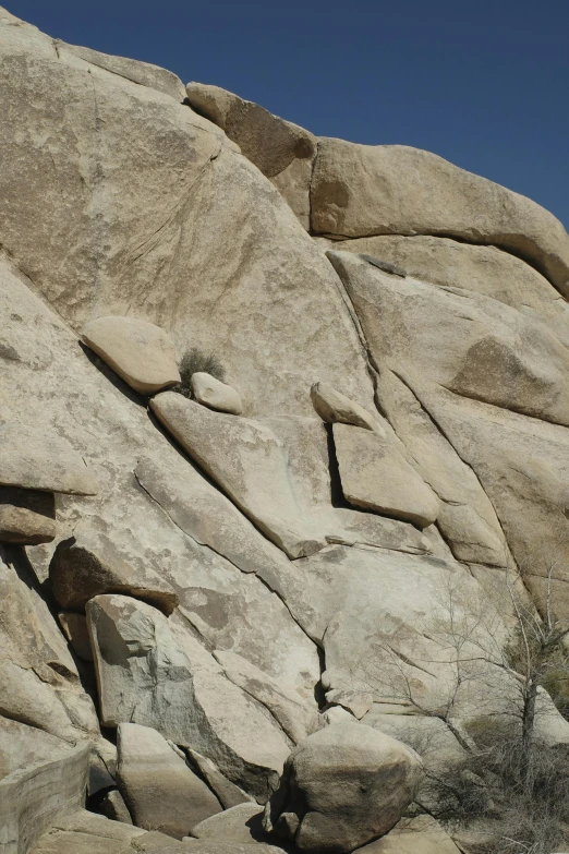 a giraffe in a large rocky area with some rocks